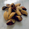 Fresh ready to eat Brazil nuts in a pile on a white marble table. 