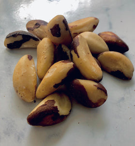 Fresh ready to eat Brazil nuts in a pile on a white marble table. 
