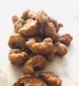 Honey cashews. They look spotty. A small handful is splayed across the table.