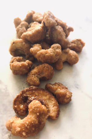 Honey cashews. They look spotty. A small handful is splayed across the table.