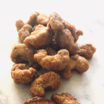 Honey cashews. They look spotty. A small handful is splayed across the table.